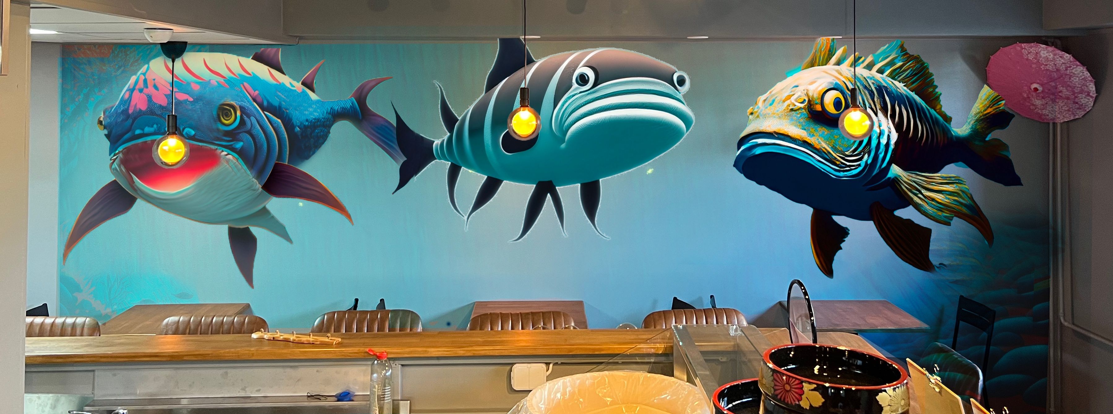 A design for a mural in a restaurant: large fish against a blue-green underwater background
